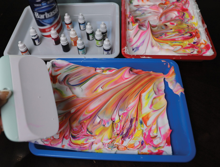 tray with shaving cream and colored dyes smeared around into a design