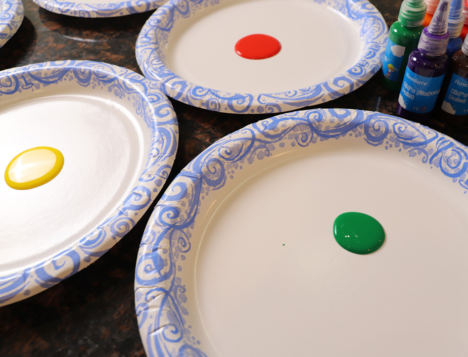 different colored finger paints on paper plates for crafts