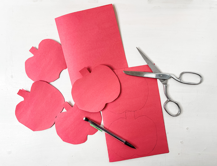 red construction paper cut into apple shapes
