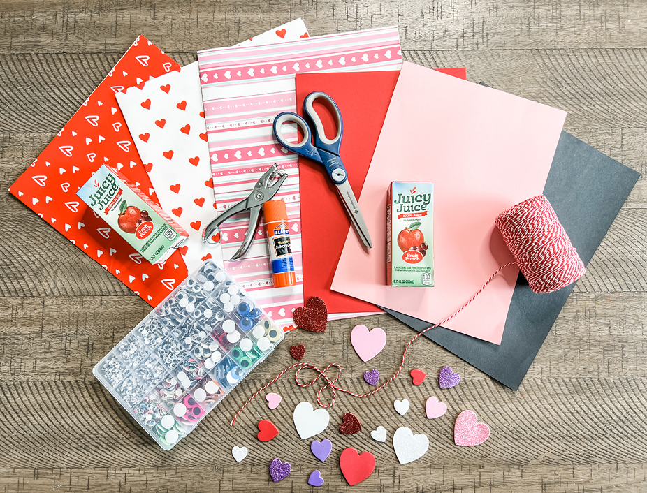 All of the love monsters craft supplies. Includes a juicy juicy box, wrapping paper, googly eyes, heart stickers, pink and red construciton paper, string, tape, and a hole punch.