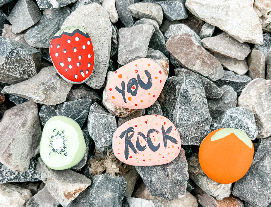 Finished activity with a bunch of painted rocks saying things like you rock, or painted as fruits