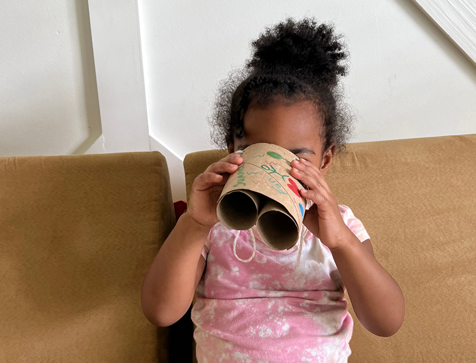 Young girl playing with her new bonocular craft