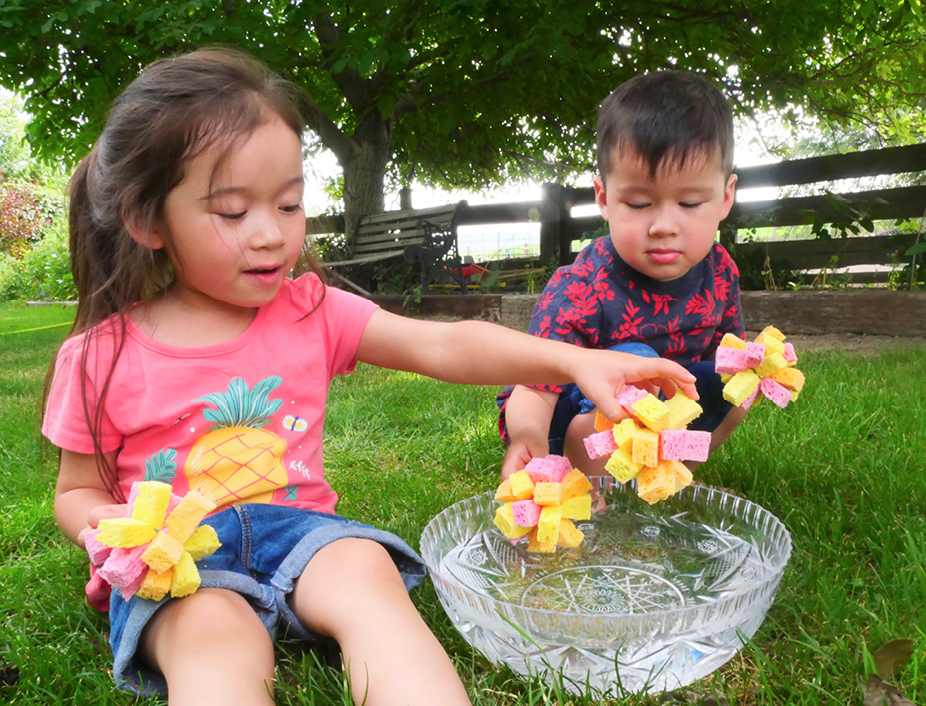Young children palying with their resuable sponge water balloons