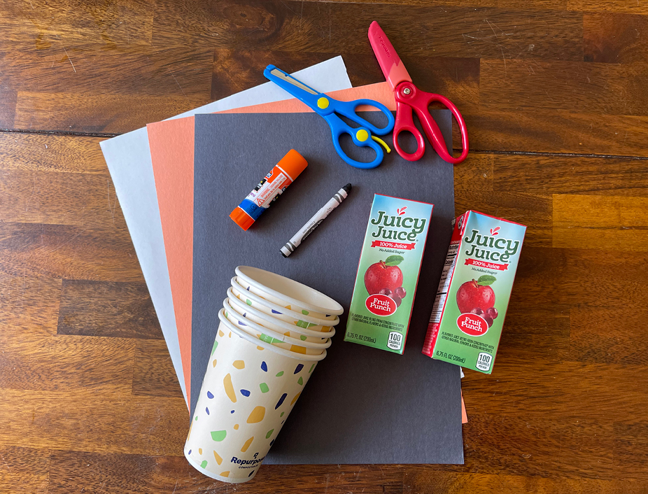 disposable cups, juicy juice boxes, construction paper, glue, scissors, caryons or markers