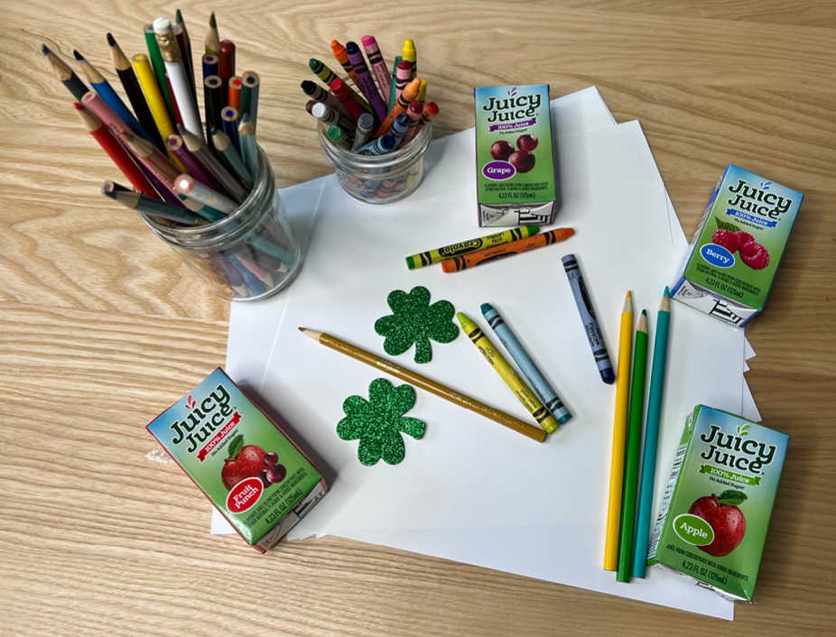 supplies for four leaf clover fortune teller. A sheet of paper, colored pencils and crayons, stickers, Juicy Juicy