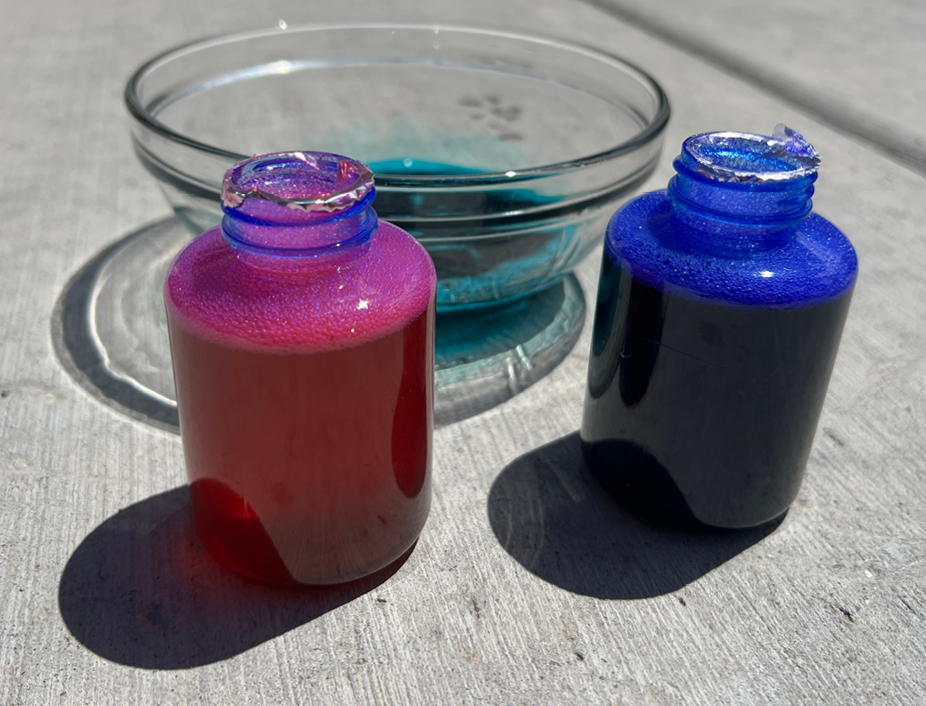 bubble solutions in two bowls with food coloring
